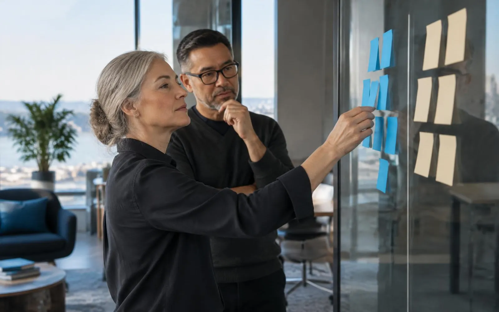 Product and engineering leaders sorting responsibilities into internally owned and externally extended groups on a glass wall.